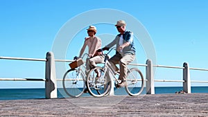 Active seniors going on a bike ride by the sea