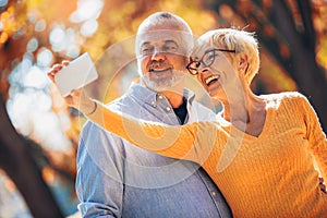 Active seniors taking selfies of them having fun photo