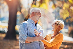 Active seniors on a walk in autumn forest