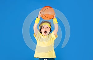 Active sport lifestyle. Basketball game. Little sporty kid throwing basketball ball. Enjoy sport game. Cute boy playing