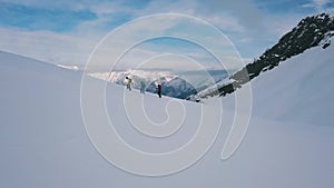 Active sport people climbing on top of high mountain for winter activities snowboarding and skiing