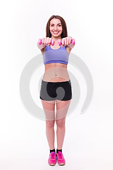 Active sportive athletic woman with dumbbells pumping up muscles biceps