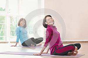 Active sportive mature women doing exercise in a gym