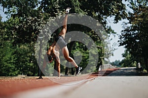 Active Sports Man Showcasing Gymnastic Skills in Natural Outdoor Park Setting