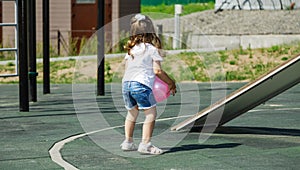 Active sports for preschoolers. Ball game for children. playing outside with a ball and walking on the playground in the park