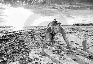 Active sportswoman in sports gear on beach workout