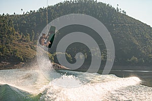 active strong man making trick in jump time with wakeboard