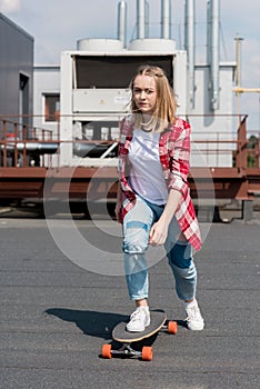 active teen girl riding skateboard