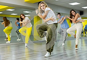 Teenage girl training breakdance Footwork moves in dance hall photo