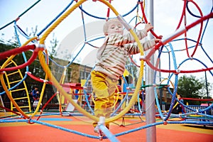 Active toddler boy having fun on playground