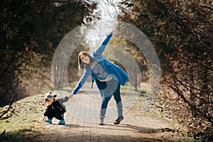 Active Toddler Holding Hands with her Mother