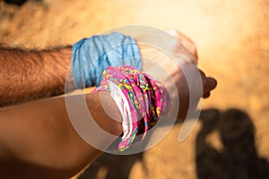 Active tourist couple hold hands with buffs in walking with sunlight.