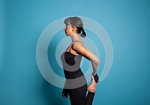 Active trainer stretching leg muscles during fitness workout