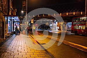 Active and vibrant urban scene featuring the bustling cityscape of London, England at night.
