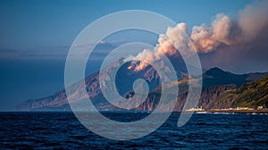 Active volcanic mountain with smoke by the ocean