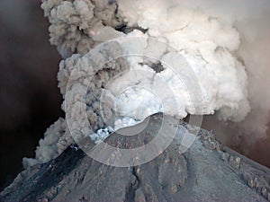 Active volcano erupting lava and clouds of volcanic ash. Kizimen, Kamchatka Peninsula