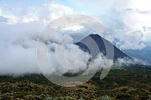 Active volcano Yzalco covered in the clouds photo