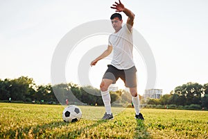 Active weekend activies. Forest on background. Young soccer player have training on the sportive field