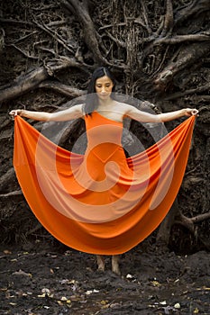 Active woman dancing with overturned tree roots in Manchester, Connecticut