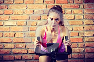 Active woman doing sport biking.