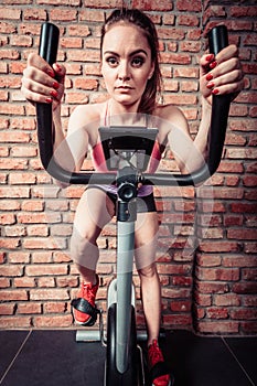 Active woman doing sport biking.