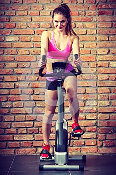 Active woman doing sport biking.