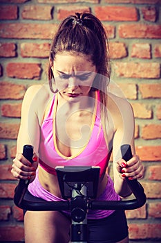 Active woman doing sport biking.