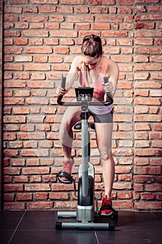 Active woman doing sport biking.