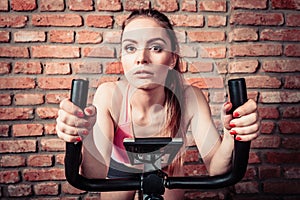 Active woman doing sport biking.