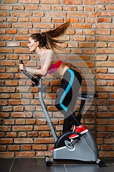 Active woman doing sport biking.