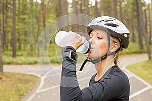 Active woman drinking from bottle