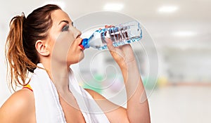 Active woman drinking water