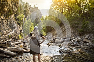 Active Woman hiking across a mountain stream on a hike