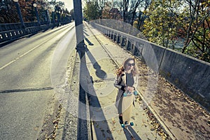 Active woman holding longboard