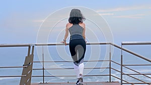 Active woman jogger on the seashore doing sport exercises, Fitness cross fit and sports concept