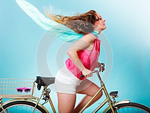 Active woman riding bike bicycle. Hair windblown.