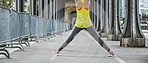 Active woman stretching on Pont de Bir-Hakeim bridge in Paris