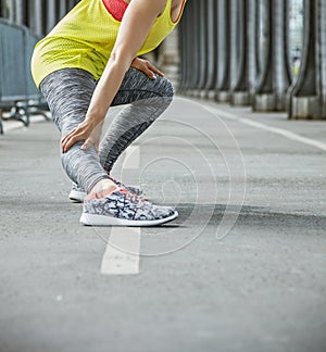 Active woman stretching on Pont de Bir-Hakeim bridge in Paris