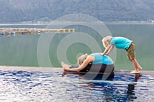 Active woman in stretching at poolside to keep fit