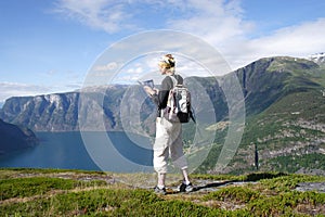 Active woman at the top of mountains over the lake