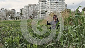 Active woman walks along the waterfront among the reeds