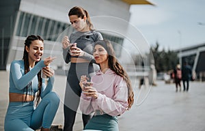 Active women enjoying a healthy snack break outdoors in sportswear