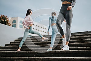Active women in sportswear jogging up steps outdoors for fitness