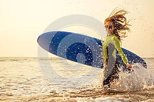 Active women with surf board enjoy watersport at vacation holidays.sport girl in surfing school instructor of windsurf