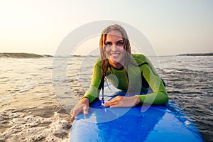 Active women with surf board enjoy watersport at vacation holidays.sport girl in surfing school instructor of windsurf