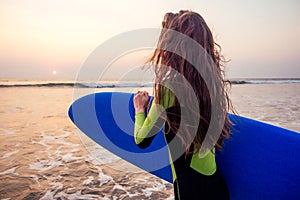 Active women with surf board enjoy watersport at vacation holidays.sport girl in surfing school instructor of windsurf