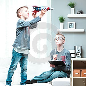 Active young boy playing with his toy spacecraft