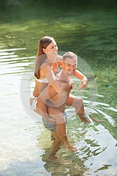Active young couple chilling out in river on a hot summer day s