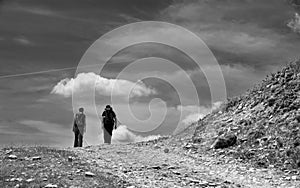 Active young couple on mountain path. Pleasant hike on the mountain. Mountain landscape