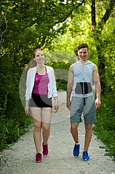 Active young couple on a wlak in the park photo